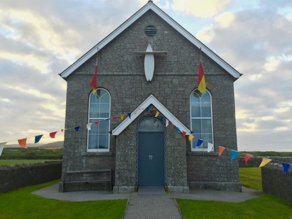 A chapel near Lands' End, Cornwall, with two surfboards for a cross. Photo by Noelle Salmi