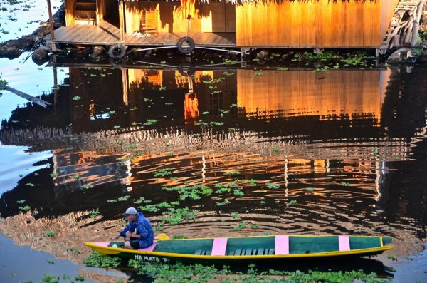 Man sitting in a canoe in Iquitos, Peru. 